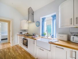 A kitchen with a sink and appliances at Mappowder Cottage Buckland Newton near Dorchester