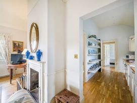 A hallway with a table and mirror at Mappowder Cottage in Buckland Newton near Dorchester