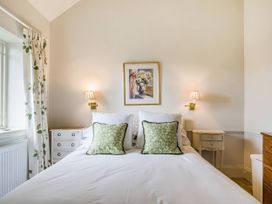 A bedroom with a bed and nightstands at Mappowder Cottage Buckland Newton near Dorchester