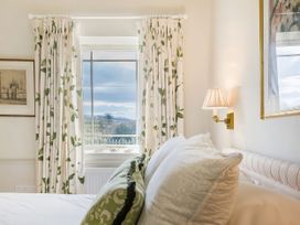 A bedroom with a window and bed at Mappowder Cottage Buckland Newton near Dorchester