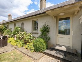 An outdoor view of a house with a garden at Mappowder Cottage Buckland Newton near Dorchester