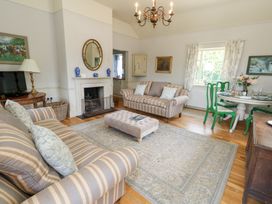 A living room with a coffee table and sofa at Mappowder Cottage in Buckland Newton near Dorchester