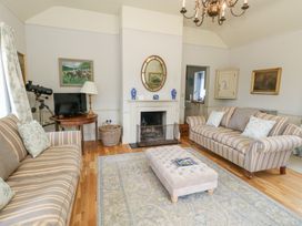 A living room with a fireplace and sofa at Mappowder Cottage Buckland Newton near Dorchester