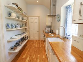 A kitchen with shelves and cooking pots at Mappowder Cottage Buckland Newton near Dorchester