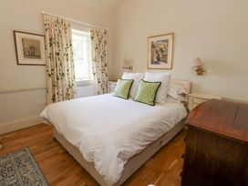A bedroom with a bed and bedside tables at Mappowder Cottage Buckland Newton near Dorchester