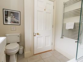 A bathroom with a toilet, door, and towel rail at Mappowder Cottage in Buckland Newton near Dorchester