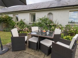 An outdoor dining area with a table and chairs at Mappowder Cottage Buckland Newton near Dorchester