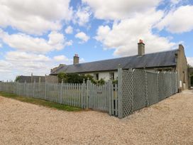 A house with a surrounding fence and garden at Mappowder Cottage in Buckland Newton near Dorchester