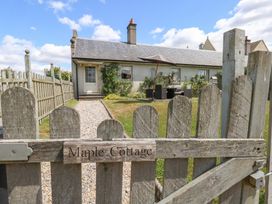 A garden view with a wooden gate at Maple Cottage Buckland Newton near Dorchester