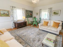 A living room with a sofa and coffee table at Maple Cottage in Buckland Newton near Dorchester