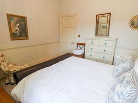 A bedroom with a bed and furniture at Maple Cottage Buckland Newton near Dorchester