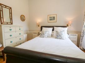 A bedroom with a bed and dresser at Maple Cottage Buckland Newton near Dorchester