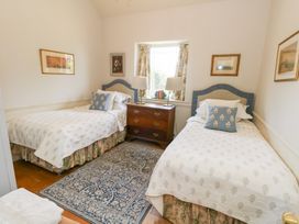A bedroom with two beds and a chest of drawers at Maple Cottage Buckland Newton near Dorchester