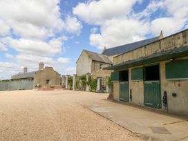 An outdoor area with a garage and stables at Maple Cottage Buckland Newton near Dorchester