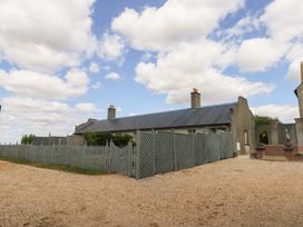A house with a fence and gravel driveway at Maple Cottage Buckland Newton near Dorchester