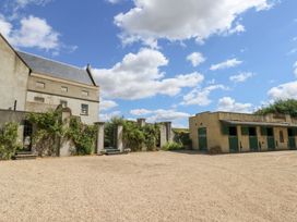 An outdoor area with a building and gravel surface at Maple Cottage in Buckland Newton near Dorchester