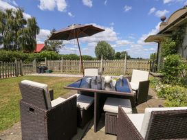 A dining area with a table and chairs at Maple Cottage in Buckland Newton near Dorchester