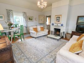 A living room with a sofa and fireplace at Maple Cottage Buckland Newton near Dorchester
