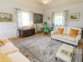 A living room with a sofa and a dining table at Maple Cottage in Buckland Newton near Dorchester