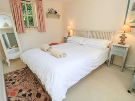 A bedroom with a bed and bedside tables at Upper Mill Barn, Coln St Aldwyns, near Bibury