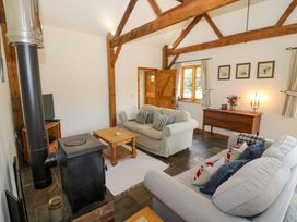 A living room with a sofa and coffee table at Robbie's Barn Fulready near Stratford-upon-Avon