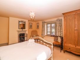 A bedroom with a bed and a chair at Elm View in Chipping Campden