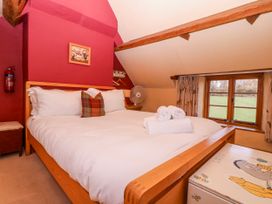 A bedroom with a bed and a window at Elm View Chipping Campden