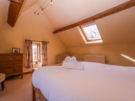 A bedroom with a bed and dresser at Elm View in Chipping Campden