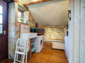 A laundry room with a washing machine and drying rack at Elm View in Chipping Campden