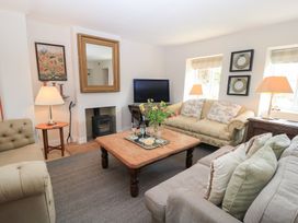 A living room with a coffee table and television at Fairview Cottage in Milton-Under-Wychwood