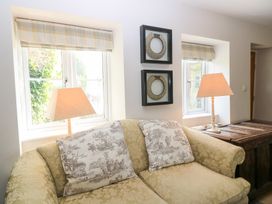 A living room with a sofa and lamps at Fairview Cottage in Milton-Under-Wychwood