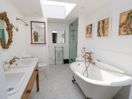 A bathroom with a bathtub, sink, and shower at Fairview Cottage in Milton-Under-Wychwood