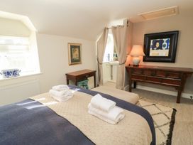 A bedroom with a bed and towels on it at Fairview Cottage in Milton-Under-Wychwood