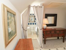 A bathroom with a toilet and shower area at Fairview Cottage Milton-Under-Wychwood