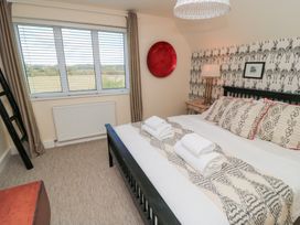 A bedroom with a bed and window at Fairview Cottage in Milton-Under-Wychwood
