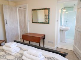 A bedroom with a table and towels at Fairview Cottage in Milton-Under-Wychwood