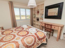 A bedroom with a bed and desk at Fairview Cottage in Milton-Under-Wychwood