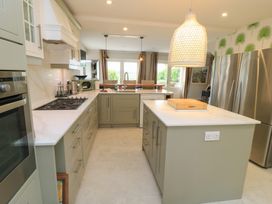 A kitchen with a large island and stainless steel appliances at Fairview Cottage in Milton-Under-Wychwood