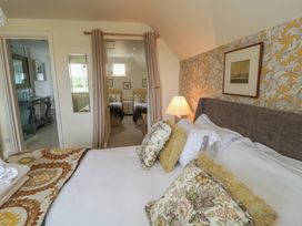 A bedroom with a bed and lamp at Fairview Cottage in Milton-Under-Wychwood