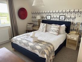 A bedroom with a bed and side tables at Fairview Cottage in Milton-Under-Wychwood
