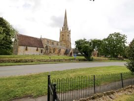 A church building with a steeple near a road at Elmhurst Cottage in Lower Quinton