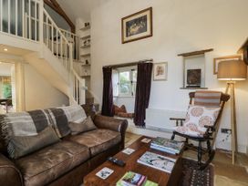 A living room with a sofa and coffee table at The Old Reading Room in Bledington near Stow-on-the-Wold