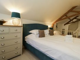 A bedroom with a bed and dresser at The Old Reading Room Bledington near Stow-on-the-Wold