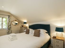 A bedroom with a double bed and two nightstands at The Old Reading Room Bledington near Stow-on-the-Wold