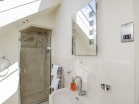 A bathroom with a shower and sink at The Old Reading Room Bledington near Stow-on-the-Wold