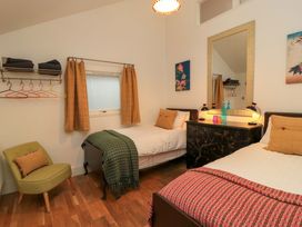 A bedroom with two beds and a mirror dresser at The Linhay in Little Coxwell near Faringdon