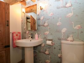 A bathroom with a sink and toilet at The Linhay near Little Coxwell