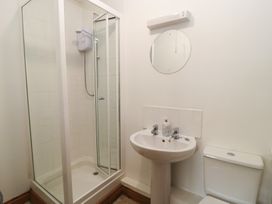 A bathroom with a shower, toilet and sink at Tithe Barn, Lyneham