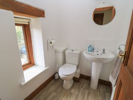 A bathroom with a toilet and sink at Tithe Barn, Lyneham
