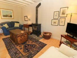 A living room with a sofa and coffee table at Cider Press Cottage in Priston Village, Bath